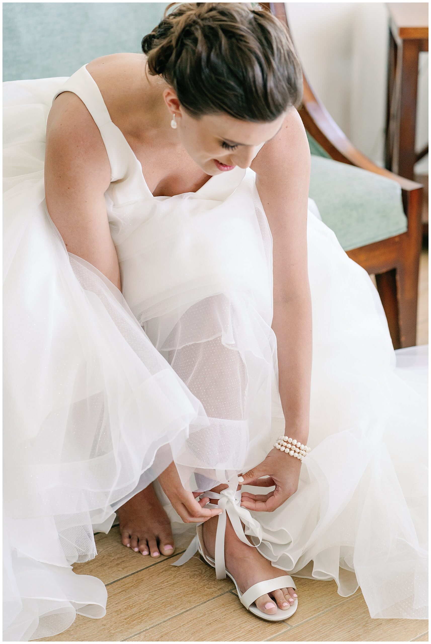 bride tying shoes